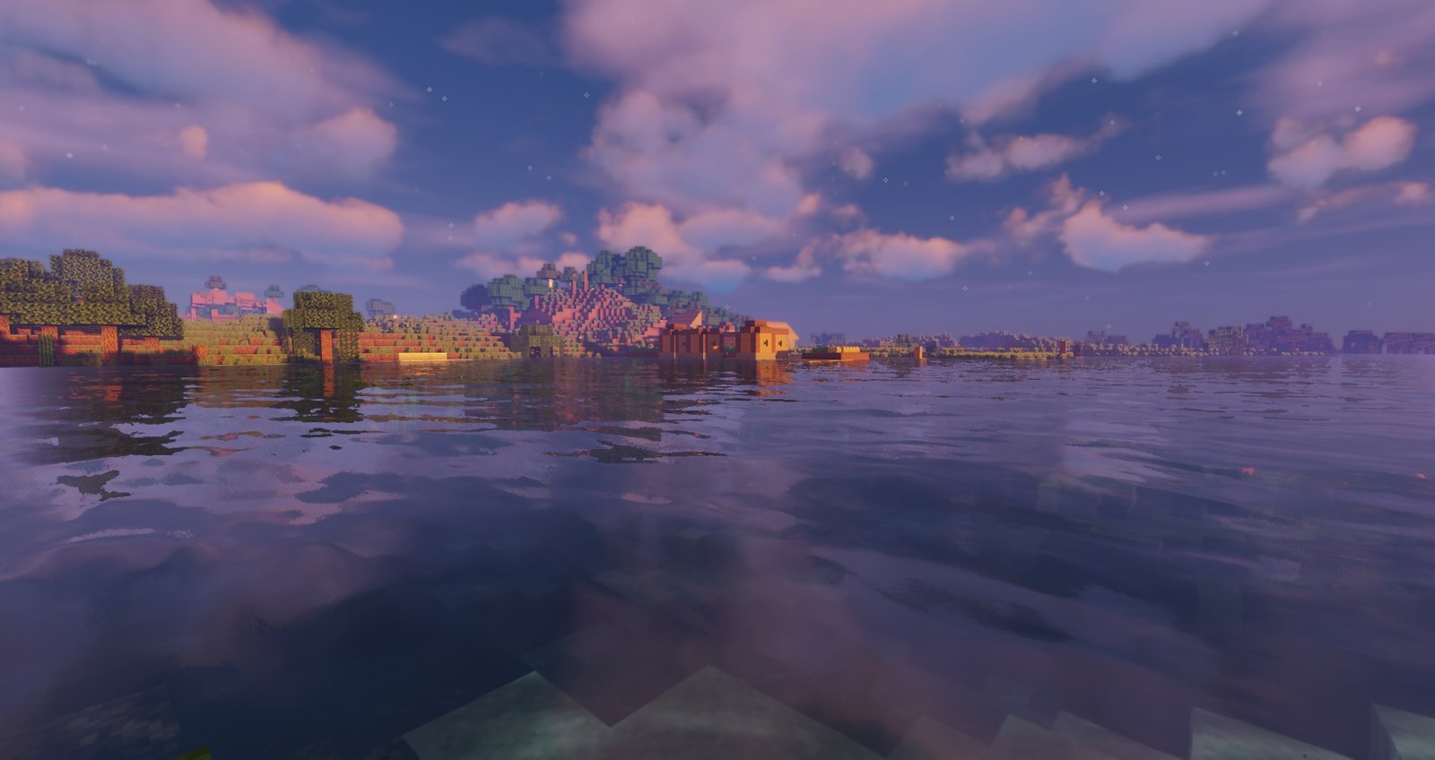 Minecraft shaders - Sildur's vibrant shaders showing a stretch of water at sunset across from a village
